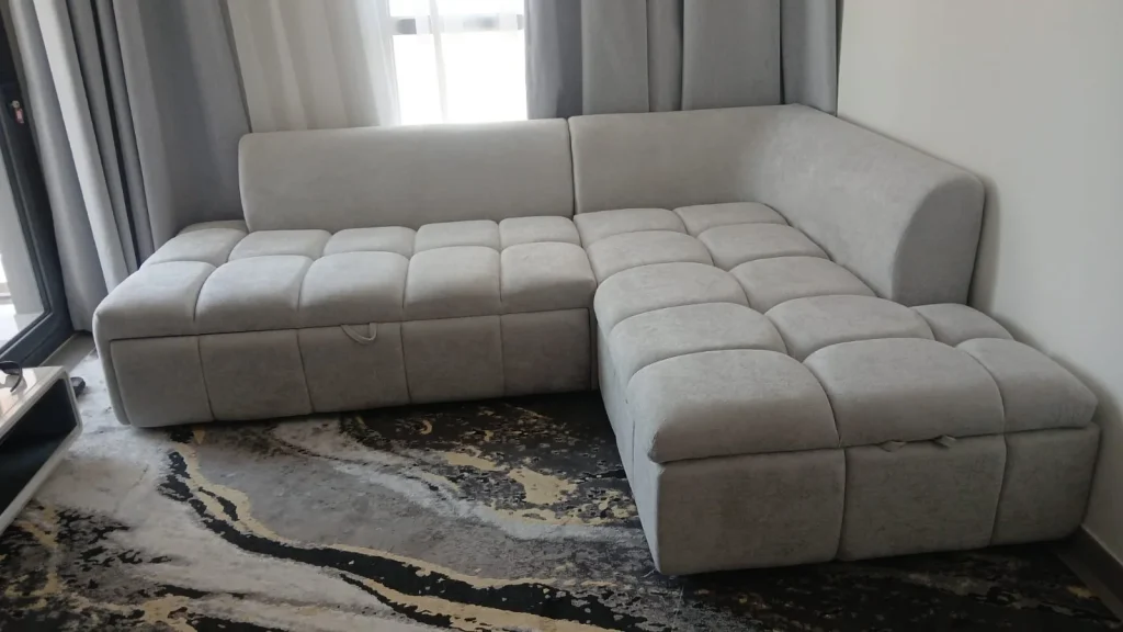 Grey L-shaped upholstered sectional sofa in a living room